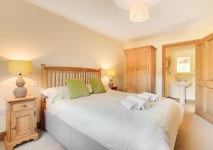 a bedroom with two beds with towels on them at Oak Lodge in Alderford