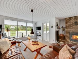 a living room with a couch and a table at Holiday Home Tholf - 100m to the inlet by Interhome in Ulfborg