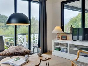 salon ze stołem i dużym oknem w obiekcie Holiday Home Aina - 250m to the inlet in The Liim Fiord by Interhome w mieście Hjerm