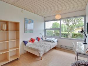 a bedroom with a bed and a large window at Holiday Home Giselle - 150m from the sea in SE Jutland by Interhome in Sønderby
