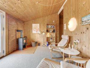 a living room with wood paneling and a fireplace at Holiday Home Siri - 400m from the sea in NW Jutland by Interhome in Thisted