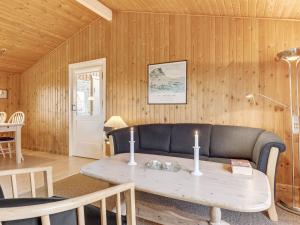 a living room with a table and a couch at Holiday Home Siri - 400m from the sea in NW Jutland by Interhome in Thisted