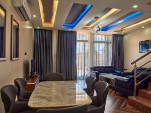 a waiting room with a table and chairs at Unique Apartment in Kigali