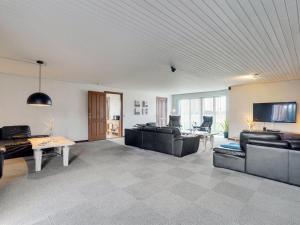 ein großes Wohnzimmer mit Sofas und einem TV in der Unterkunft Holiday Home Rahild - 2km to the inlet in The Liim Fiord by Interhome in Thyholm
