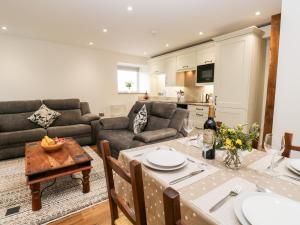 a kitchen and living room with a table and a couch at 2 Barn Cottages in Halifax