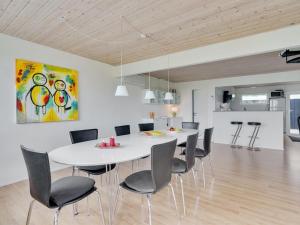 a dining room with a white table and chairs at Holiday Home Dunja - 200m to the inlet in The Liim Fiord by Interhome in Vinderup