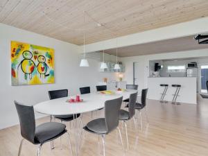 a dining room with a white table and chairs at Holiday Home Dunja - 200m to the inlet by Interhome in Vinderup