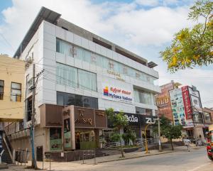 a tall white building on a city street at MySpace Kadison in Dāvangere