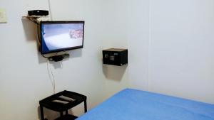 a room with a tv on a wall with a table at Oasis de Tolú in Tolú