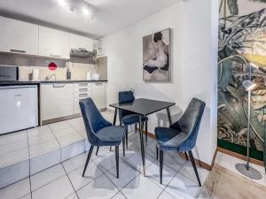 a kitchen with a table and chairs in a room at Quiet & Comfy apartment on Av du Casino in Montreux