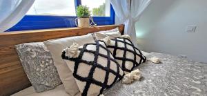 a bedroom with a bed with pillows and a window at Casa Fiona in Costa Calma +20 photos