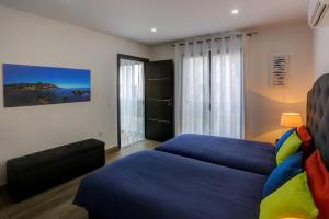 a bedroom with two beds and a large window at Appartements Supérieurs in Saint-Aygulf