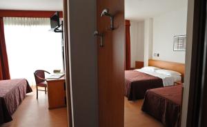 Postel nebo postele na pokoji v ubytování Hotel Fenix