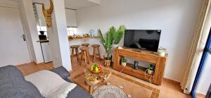 a living room with a couch and a flat screen tv at Casa Fiona in Costa Calma