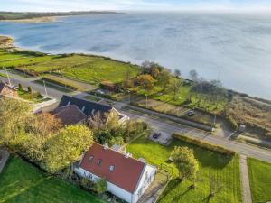 an aerial view of a house next to the water at Holiday Home Rina - 30m to the inlet in The Liim Fiord by Interhome in Fur