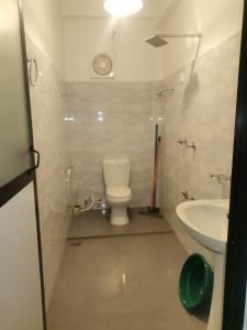 a small bathroom with a toilet and a sink at Ceylon Ramble Villa in Hikkaduwa