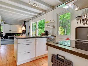 a kitchen with white cabinets and a large counter top at Holiday Home Ethil - 300m to the inlet in The Liim Fiord by Interhome in Lihme
