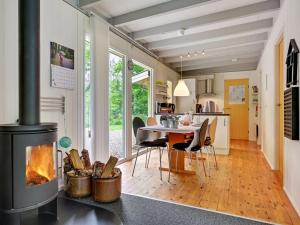 a kitchen and dining room with a fireplace in a house at Holiday Home Ethil - 300m to the inlet in The Liim Fiord by Interhome in Lihme