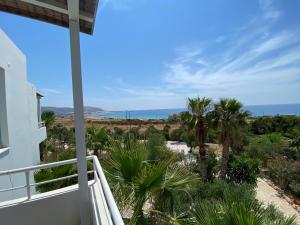 a view of the ocean from the balcony of a house at Hotel Plakures in Falasarna