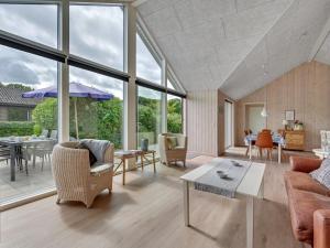 a living room with a couch and a table at Holiday Home Regni - 300m to the inlet in The Liim Fiord by Interhome in Nykøbing Mors