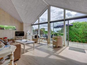 een woonkamer met een groot raam en een bank bij Holiday Home Regni - 300m to the inlet in The Liim Fiord by Interhome in Nykøbing Mors
