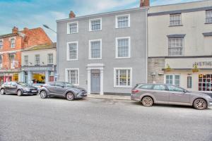 three cars parked on the side of a street at Cozy & Elegant 1bedroom House in Somerset Sleeps 2 By Hinkley Homes Short Lets & Serviced Accommodation in Bridgwater
