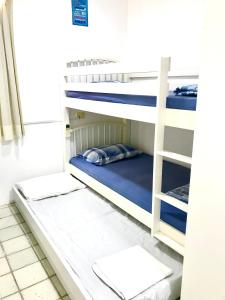 a bunk bed in a room with blue bunk beds at Gavoa Resort - 2 quartos - BL D apt 209 in Igarassu +36 photos
