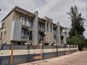 a building with a fence in front of it at Unique Apartment in Kigali