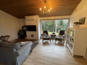 a living room with a couch and chairs and a tv at Holiday Home Gerret in SE Jutland by Interhome in Bryrup