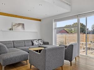 sala de estar con sofá gris y sillas en Holiday Home Atanasij - from the sea in NE Jutland by Interhome en Nørre Hurup