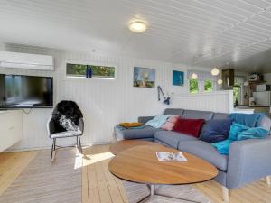 a living room with a couch and a table at Holiday Home Self - 400m to the inlet in The Liim Fiord by Interhome in Løgstrup