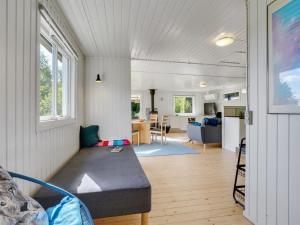 a living room with a couch and a kitchen at Holiday Home Self - 400m to the inlet in The Liim Fiord by Interhome in Løgstrup