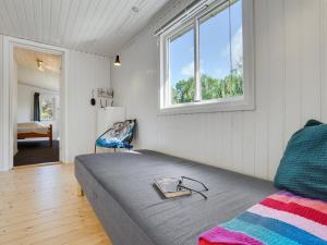 a bedroom with a bed with a book on it at Holiday Home Self - 400m to the inlet in The Liim Fiord by Interhome in Løgstrup