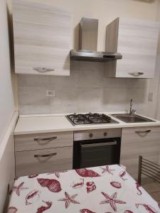 a small kitchen with a stove and a sink at Rooms Monteverde in Rome