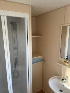 a bathroom with a shower and a sink at Golden Palm Resort PG163 in Chapel Saint Leonards