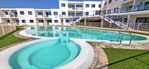 a large swimming pool in front of a building at Casa Fiona in Costa Calma