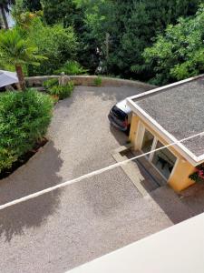 a car parked in a parking lot with a shed at Apartments Ivna Bilek in Opatija +3 photos