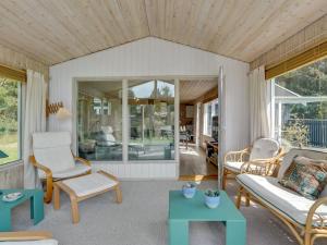 een woonkamer met een bank en een tafel bij Holiday Home Glum - 300m from the sea in NE Jutland by Interhome in Sæby