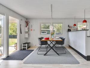 a kitchen with a table and chairs in a room at Holiday Home Sybille - from the sea in NE Jutland by Interhome in Hals