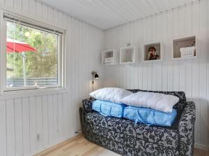 a room with a bed and a window and a couch at Holiday Home Sybille - from the sea in NE Jutland by Interhome in Hals