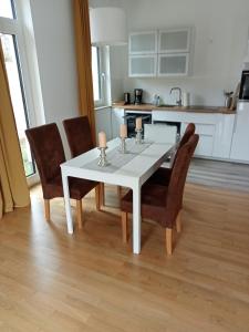 - une table à manger blanche et des chaises dans la cuisine dans l'établissement Stadtgrün 2, à Berlin