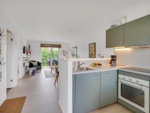 een keuken met witte kasten en een aanrecht bij Apartment Sipi - 100m from the sea in NE Jutland by Interhome in Hals