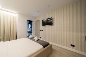 a bedroom with a large bed and a television on the wall at Luxury City Centre in Alicante