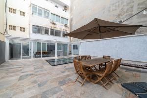 een terras met een tafel, stoelen en een parasol bij Luxury City Centre in Alicante