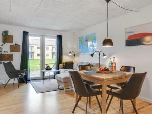 comedor y sala de estar con mesa y sillas en Apartment Amaryllis - 100m from the sea in NE Jutland by Interhome en Hals
