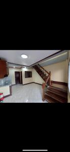 a room with a staircase and a stair case at Nober Apartments in Puerto Princesa City