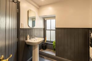 a bathroom with a sink and a mirror at Royal Oak Pub in Cartmel