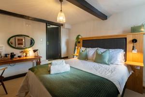 a bedroom with a large bed and a desk at Royal Oak in Cartmel