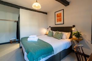 a bedroom with a large bed in a room at Royal Oak Pub in Cartmel +12 photos