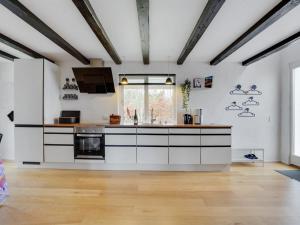 an open kitchen with white cabinets and a window at Holiday Home Edith - 1km from the sea by Interhome in Hals